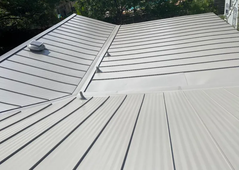 Solar attic fan installed on a metal roof for Roof Ventilation in Spring Arbor